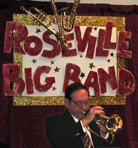Bob Hallquist solos beneath the Roseville Big Band sign.