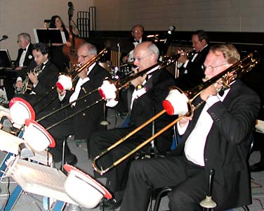 The trombone section plays with cup mutes.
