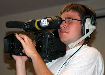 Joey holds the camera on his right shoulder.