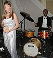 Heather plays Afuche; Kenne plays drum set.