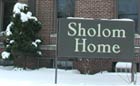 The Shalom Home sign in winter.