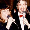 Mary Lou Peterman and Glen Newton sing for the camera.