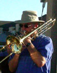 Mike's trombone gleams as he plays.
