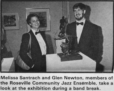 Melissa Santrach and Glen Newton, members of the Roseville Comunity Jazz Ensemble, take a look at the exhibition during a band break.