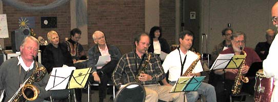 Four saxes in front, six others in back listen.