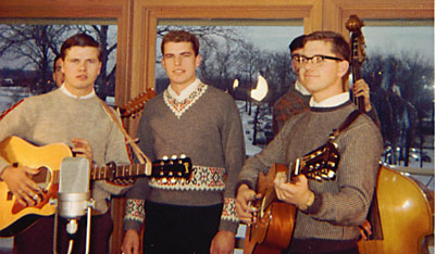 The trio and accompanists pose for the camera in ski sweaters.