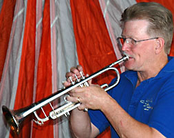 John plays a silver trumpet