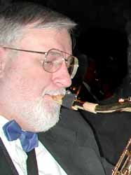 Dan plays tenor sax in black suit and blue bow tie.