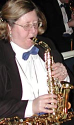Kay plays a curved soprano sax, with her alto in her lap.