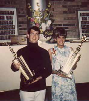 Glen and Joyce hold the winners' trophies.