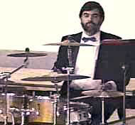 Seated at his drum set, Jim concentrates on the music.