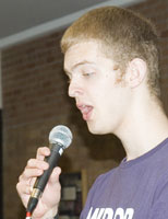 Matt sings into a microphone.