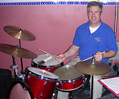 Craig poses for the camera at his drum set.