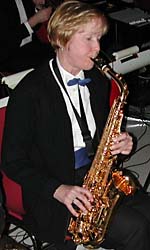 Dressed in black and white with the band's blue bow tie and cummerbund, Mary plays alto sax.