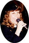 Mary Lou smiles at the camera while singing. Bigger pictures total 127K.