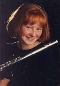 In her high school senior picture, Kris holds her flute.