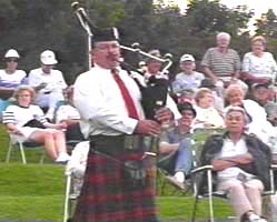 Lynn Ista, bagpipe soloist, moves through the audience.
