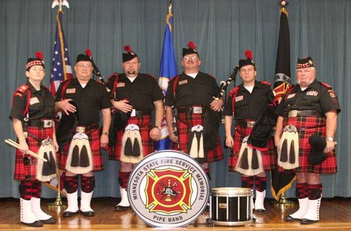 Four pipers and two drummers pose in this 2006 photo.